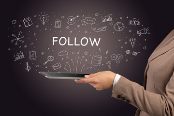 Close-up of a touchscreen with FOLLOW inscription, social media concept