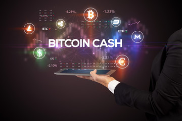 Fototapeta premium Close-up of a touchscreen with BITCOIN CASH inscription, business opportunity concept