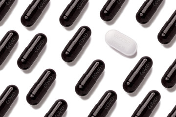 Top view of many white and black pills isolated on white background.