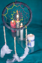 Fototapeta na wymiar DREAM CATCHER AND MANDALA WITH CANDLES AND GREEN TABLECLOTH