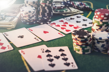 view of a gaming table with many poker card and chips green mat