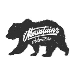 Fototapeta na wymiar Mountains adventure. Silhouette of grizzly bear on grunge background. Design element for poster, card, banner, sign.