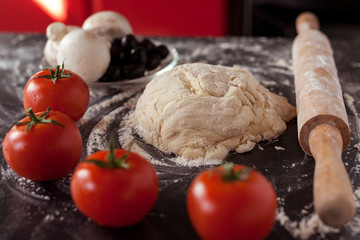 Making pizza at home. Fresh original Italian raw pizza, preparation in traditional style.
