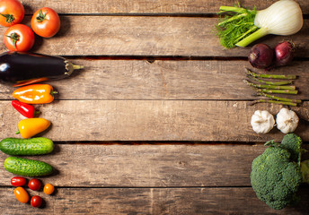 Exposition of fresh organic vegetables on wooden table. tomato, pepper, broccoli, onion, garlic, cucumber,  eggplant, black Eyed Peas, ecological bag.