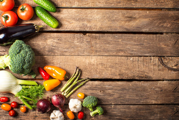 Exposition of fresh organic vegetables on wooden table. tomato, pepper, broccoli, onion, garlic, cucumber,  eggplant, black Eyed Peas, ecological bag.