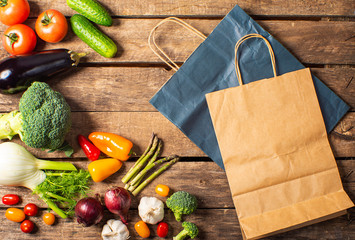 Exposition of fresh organic vegetables on wooden table. tomato, pepper, broccoli, onion, garlic, cucumber,  eggplant, black Eyed Peas, ecological bag.