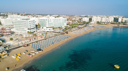Aerial bird's eye view of Sunrise beach Fig tree, Protaras, Paralimni, Famagusta, Cyprus.The famous tourist attraction family bay with golden sand, boats, sunbeds, restaurants, water sports from above