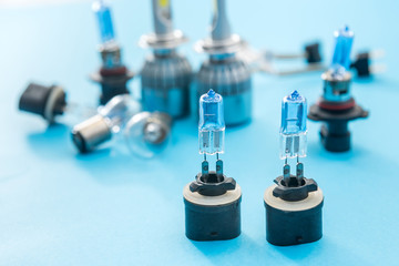 Electric car bulbs for headlight isolated on color background. Modern glass automotive lamp