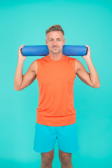 Be training inspiration. Fit man hold yoga mat blue background. Yoga training. Physical training activity. Yoga and pilates. Fitness and sport. Workout at gym. Get started your fitness training