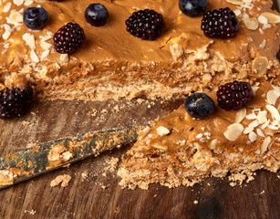 piece of meringue, baked egg white and butter cream cake decorated with blueberries