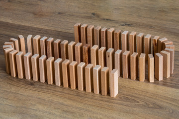 lined wooden domino tiles, on wooden top