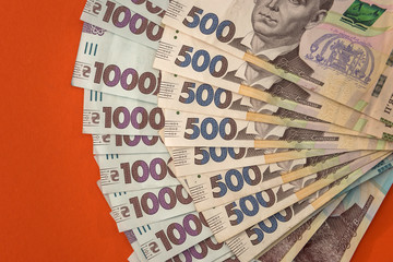 lot of ukraine money, 1000 and 500 new banknotes isolated on red. Hryvnia UAH