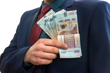  man in a suit with a huge pile of Ukrainian money. 1000 hryvnia. UAH.