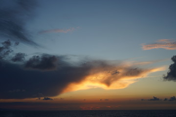 Fototapeta premium Beautiful sunset sky above the clouds. Sunlight in the clouds of heaven.