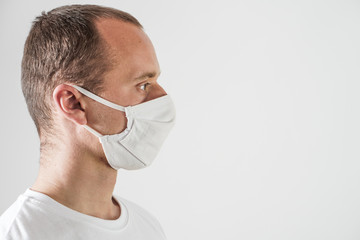 Young man wearing protection face mask against coronavirus. 