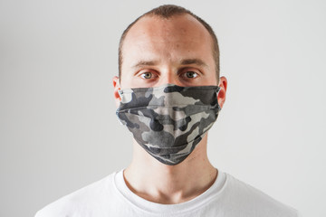 Young man wearing protection face mask against coronavirus. 