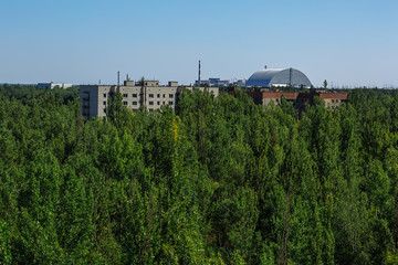 Abandoned buildings and sarcophagus above the reactor in ghost town Pripyat Chornobyl Zone