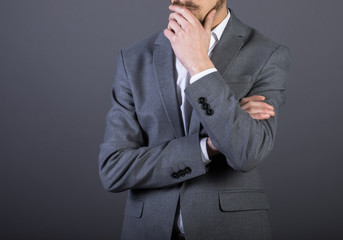 thinking man hand mouth