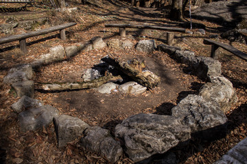 wooden benches by an extinct fire