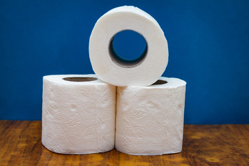two roll of white toilet paper on wood desk table