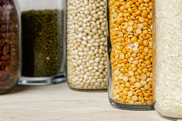 Raw cereals or beans in glass jars close up. Vegan and vegetarian food. Close up.
