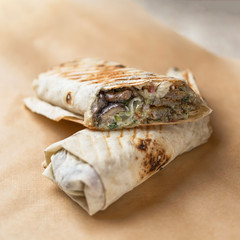 Doner kebab Shawarma cut with filling on parchment paper
