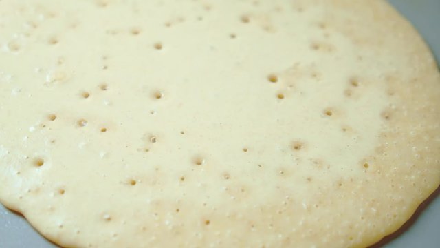 Flapjack, tortilla, pizza, bake fry pancake in pan. Close up. Steam, bubbles.