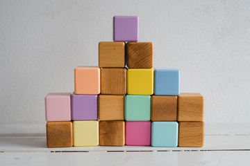 The wooden cubes are multicolored and natural. Children's cubes.