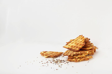 Waffle cookies and seeds isolated on a white background.
