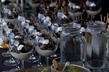 sweet and sour dessert of chia seeds yogurt, chocolate, fruit and marshmallow, fashionably served in glasses, party dinner, healthy food concept