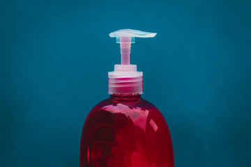 Pump bottle of red soap for cleaning and disinfecting hands