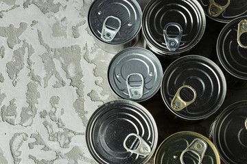 many cans with meals such as meat and fish on the table, conserved food, close up