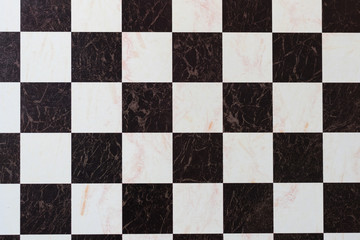 checkers or chess game board with black and white squares