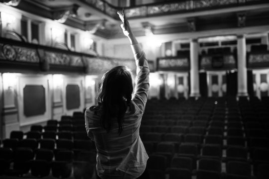 Entertainer Performing On A Stage In A Empty Theater,concert Hall Without Fans.No Audience.COVID-19 Canceled Show.Opera House Without Spectators.Playing To Empty Seats.Actor/singer Entertaining No One