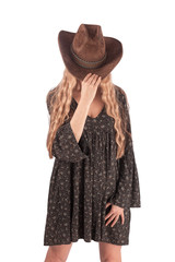 Fototapeta premium Girl dressed in a folk dress and a cowboy hat, isolate on a white background.