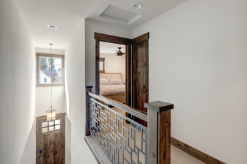 Hallway with staircase and open door to bedroom.