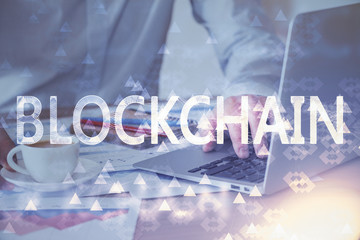 Crypto currency theme hologram with businessman working on computer on background. Concept of...