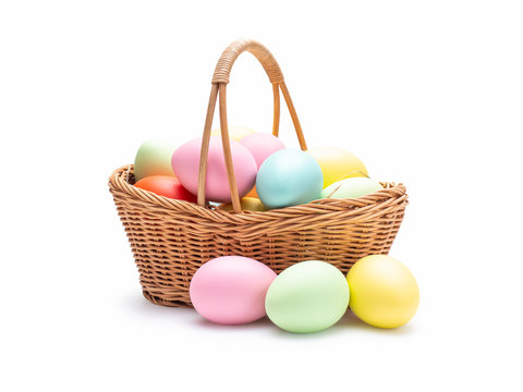 Multi colors Easter eggs in the woven basket isolated on white background with clipping path.