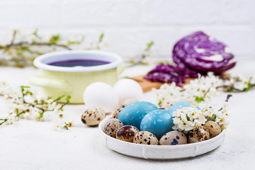 Fototapeta na wymiar Process of painting Easter eggs in blue
