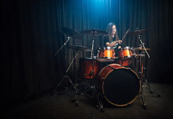 Woman playing drums during a live performance