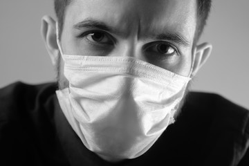 Doctor in a medical mask is upset about the coronavirus and the quarantine.