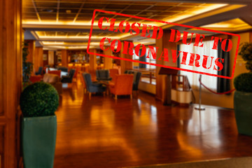 Defocused, blurred view of interior of traditional bar or restaurant, empty and closed due to coronavirus or covid 19 pandemics