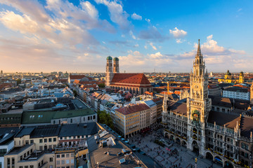 Fototapeta premium Aerial view of Munich - Marienplatz, Neues Rathaus and Frauenkirche from St. Peter's church on sunset. Munich, Germany