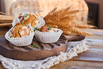 Delicious homemade coconut cinnamon muffins and caraway leafs on old white tray. Healthy food concept with copy space. Against the background of dry ears of wheat. in the style of rustic.