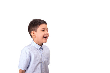 A cheerful young boy  laughes at something  and looks to the side, isolated