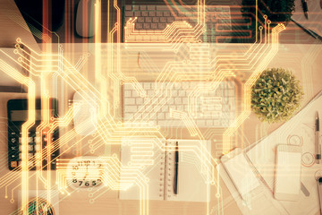 Technology hologram drawing over computer on the desktop background. Top view. Double exposure. Tech concept.