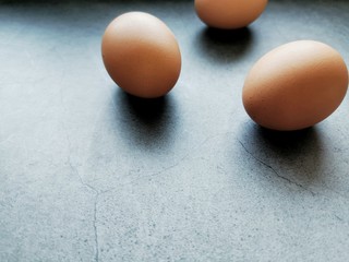 Fresh chicken eggs on dark background. Easter background. Minimal style. Copy space. 
