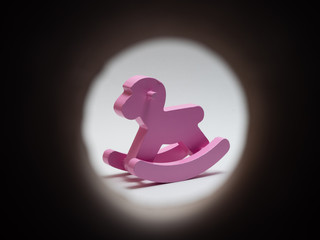 wooden pink horse rocker on white background
