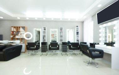 Focus on ring light and tv. Blurred interior of beauty salon