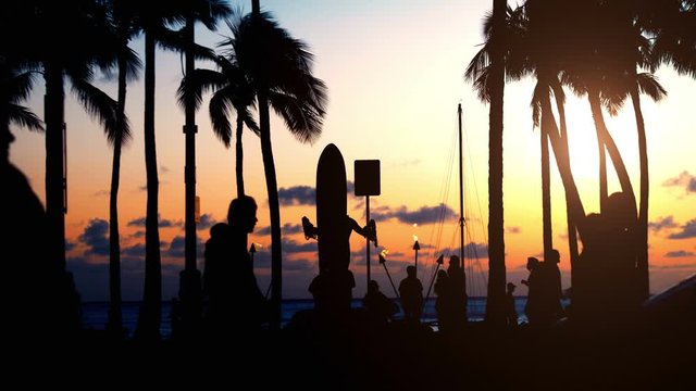 Tourists walking at sunset in Waikiki beach Hawaii in 4k slow motion 60fps